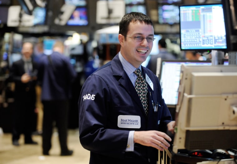 Image: Specialist Neil Gallagher smiles as he works on the floor of the New York Stock Exchange Tuesday